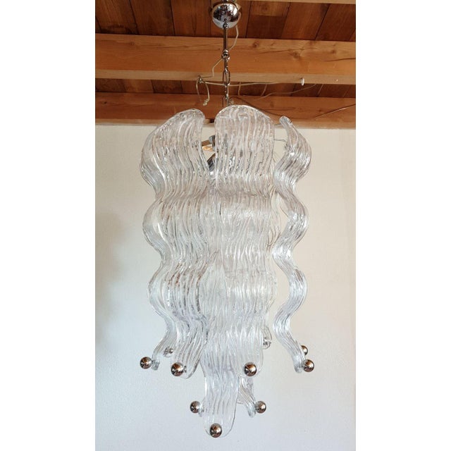Tall mid-century modern Murano glass chandelier with chrome fittings, attributed to Mazzega, Italy 1970s. Two chandeliers...