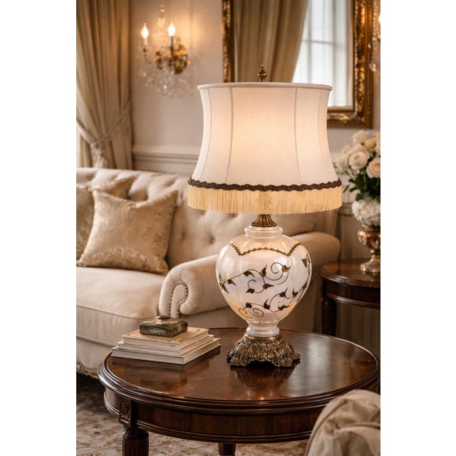 This vintage Hollywood Regency table lamp features a luminous opaline glass body with an iridescent finish, embellished...