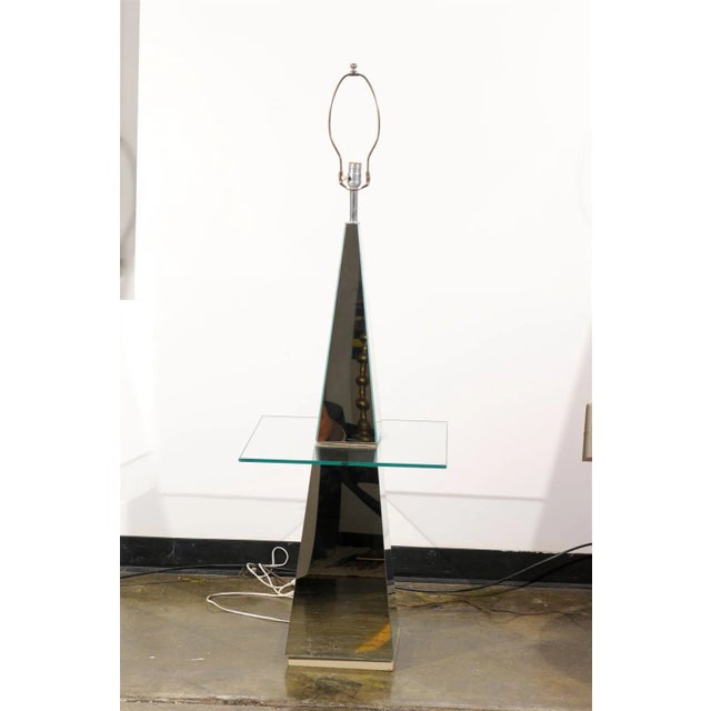 Vintage mid-century modern floor lamp made of mirror glass in a pyramid shape and holding a glass table top.