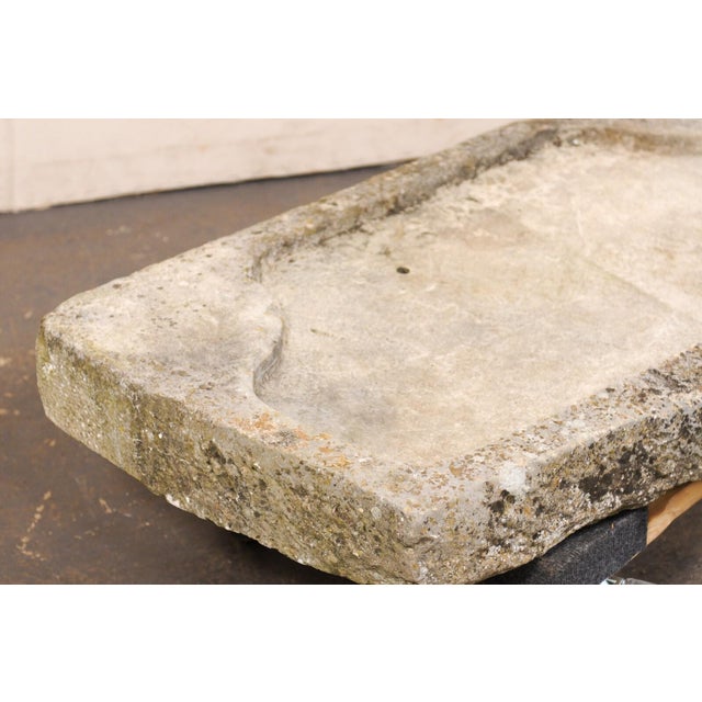 A Spanish hand-carved limestone trough from the 19th century, possibly older. This antique stone trough from Spain has an...