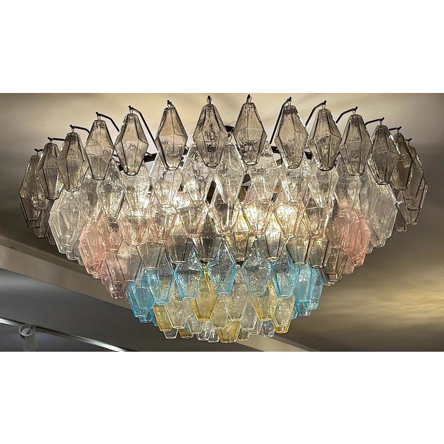 This chandelier consists dozens of hand blown gray, amber , pink , light blue and clear "poliedri" made of murano glass...