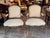 Pair of 19th century French armchairs with carved walnut toned frames. The arched backs are topped with carved floral...