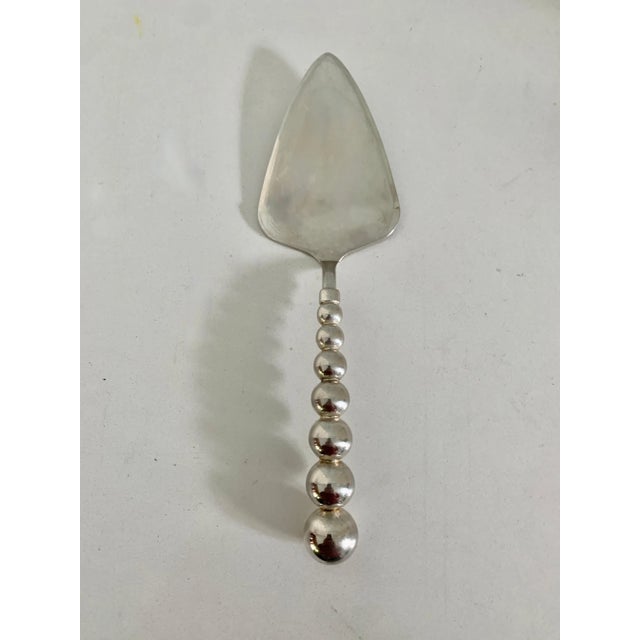 A Modernist Cake Server in silver plate. The piece has consecutive spheres leading to the server - a modern and chic piece...