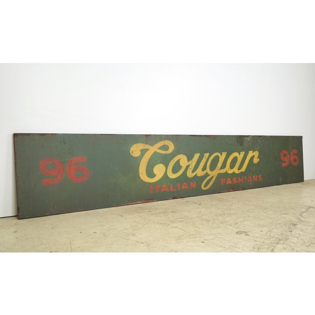 Reclaimed movie set sign made of aluminum in a yellow, red, and green color. The sign reads "96, Cougar, Italian...