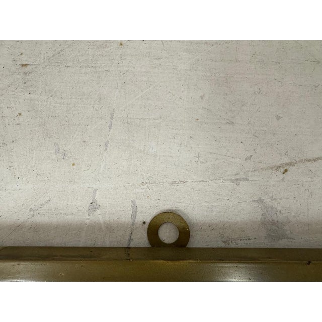 1950s brass shield shape mirror Italy 1950s This elegant mid-century Italian wall mirror features a sleek brass frame with...