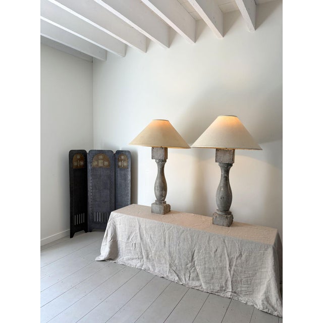 A pair of statuesque balustrade lamps. These decorative french table lamps have been formed from balustrade columns,...