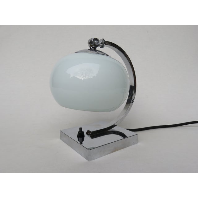 The bedside table lamp was designed in the strict formal language of Art Deco - square stand, rectangular lamp arm. The...