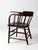 An antique early 20th-century writing arm chair by the Crocker Chair Company of Sheboygan, Wisconsin, featuring a curved...
