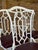 A fabulous set of four vintage faux bamboo swivel dining chairs featuring sculptural metal frames with intricate geometric...
