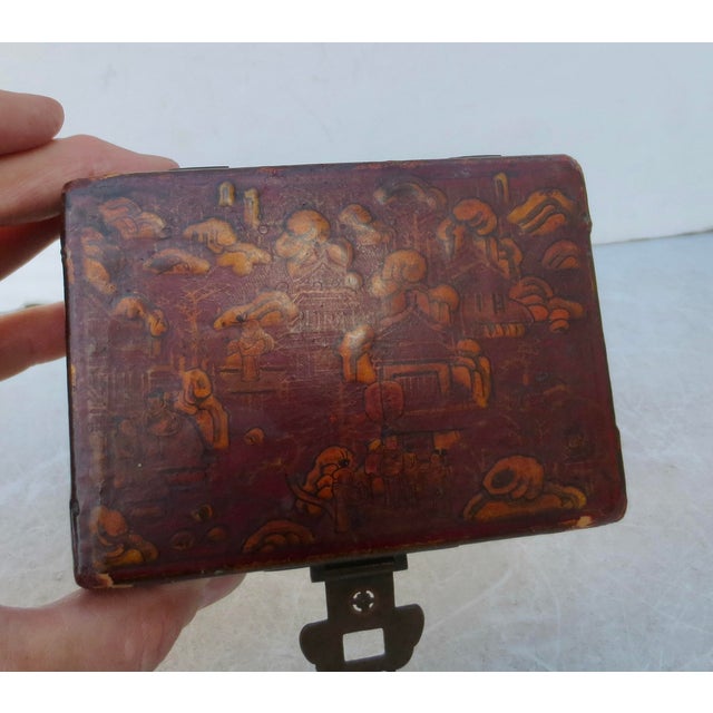 Antique leather card box with pierced brass hardware. Painted with a gilt scene on the top and inside the lid. Antique...
