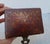 Antique leather card box with pierced brass hardware. Painted with a gilt scene on the top and inside the lid. Antique...