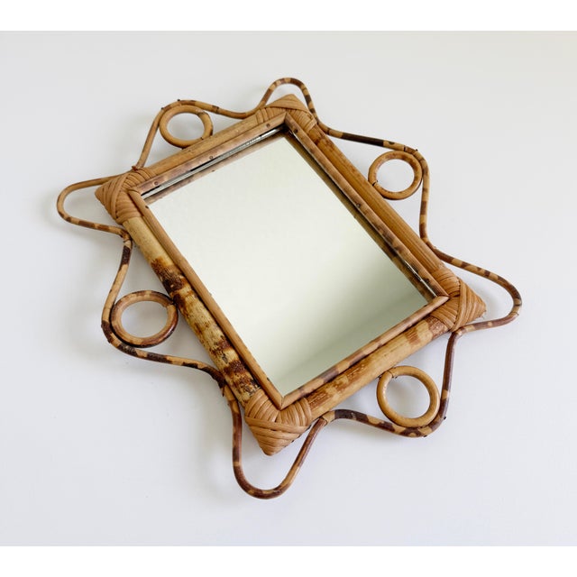 This shape! A fun vintage mid-century modern Italian wall mirror crafted from bamboo and rattan, dating back to the...