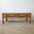 The cathedral arch apron on this vintage rattan cocktail table is the detail that places it firmly in the tradition of...