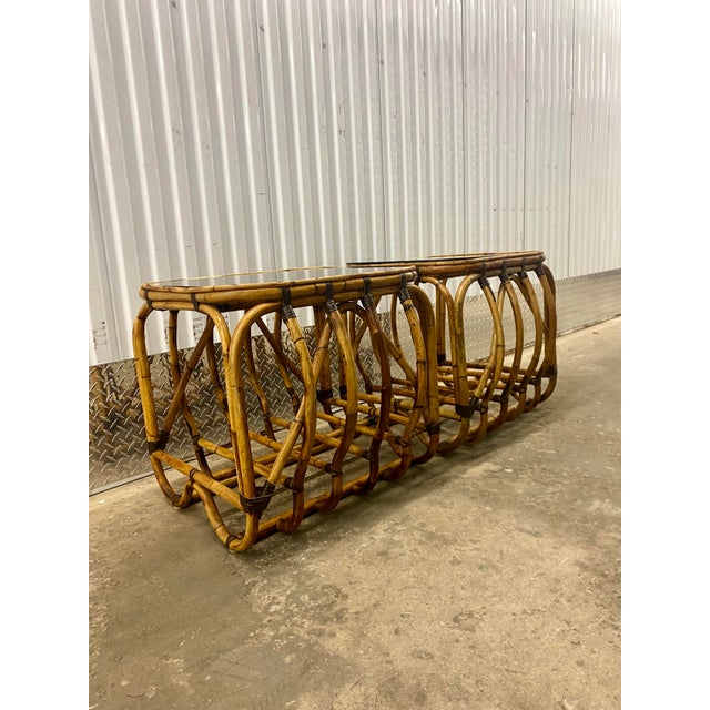 Vintage Rattan and leather strips (to attach pieces together ) side tables featured lower shelf and smoke glass top...