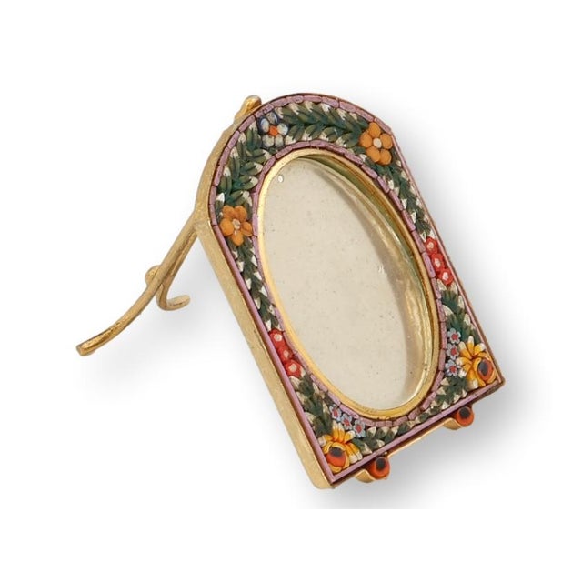 This Italian micromosaic picture frame features finely set glass tesserae arranged in a floral border of jewel tones,...