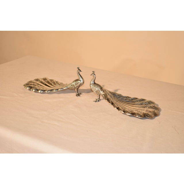 Circa 1920's pair of wonderfully artistic sterling silver bon bon dishes in the form of peacocks, signed Gorham. The...