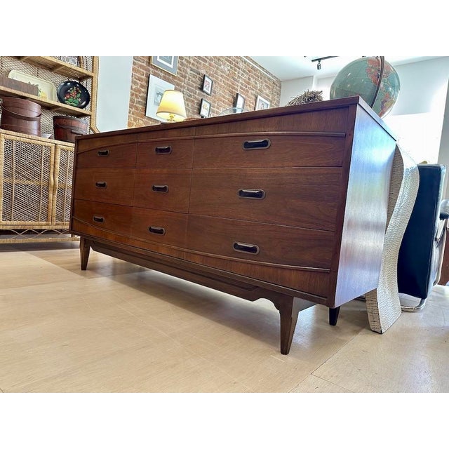 Mainline by Hooker Furniture 9 drawer lowboy dresser in walnut veneers. Known for its distinctive bowed facade and...