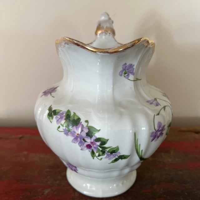 Maddocks Lamberton Works Floral Patterned Pitcher / Vase Features: floral patterns in lavender and green on exterior of...