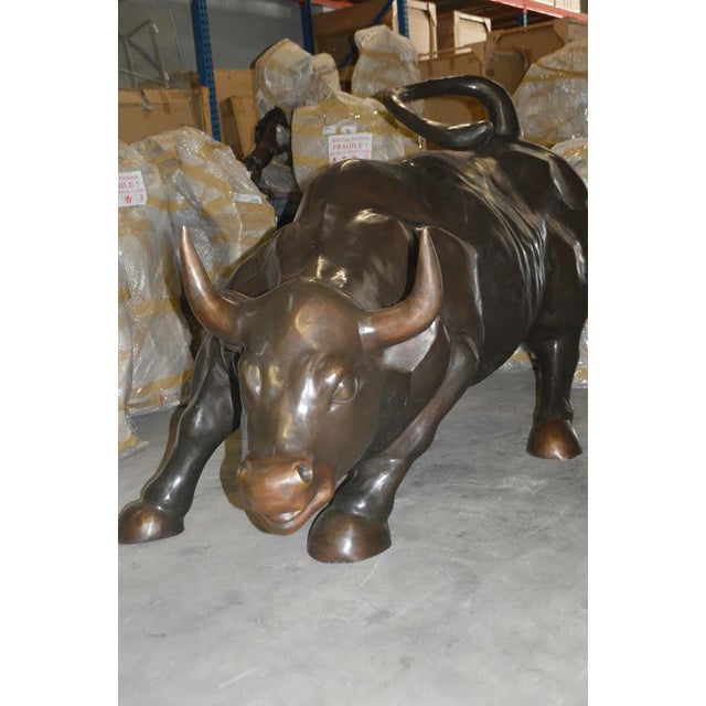 A giant Charging Bull, which is sometimes referred to as the Wall Street Bull or the Bowling Green Bull, is a bronze...