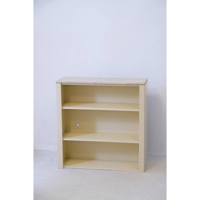 This elegant shelf combines timeless design with quality materials, such as delicate travertine stone and the frames are...