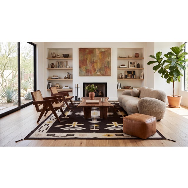 Elevate your interior with this striking hand-woven wool rug featuring a modern interpretation of traditional Navajo...