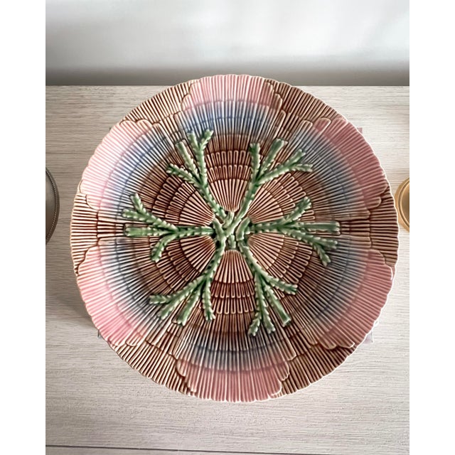 A striking textured ceramic plate by Portuguese maker Bordallo Pinheiro, featuring dimensional seaweed relief at the...