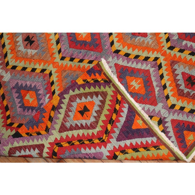 A handmade one of a kind midcentury Turkish Kilim featuring dazzling colors. Size: 6' x 8'6".