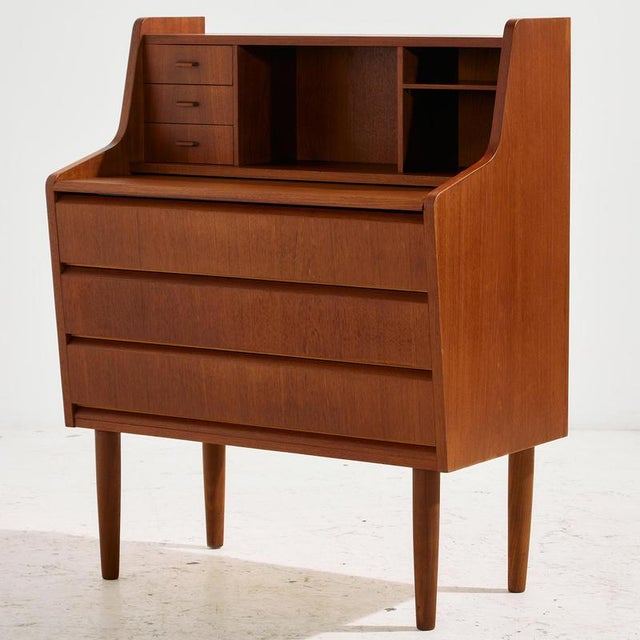 Danish teak bureau desk in restored condition with special shaped handles, six drawers and extendable writing board with...