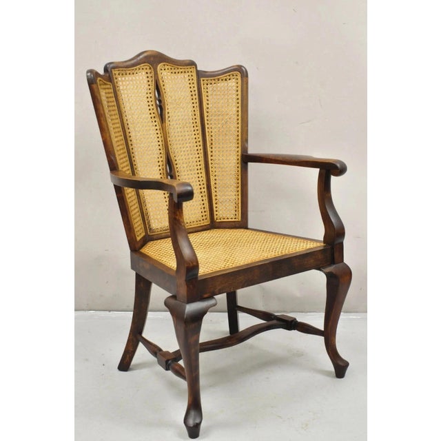 Antique Victorian Walnut and Cane Carved Lounge Arm Chair w/ Queen Anne Legs. Circa Early 20th Century. Measurements:...