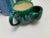 Rustic handmade set of three vintage pottery mugs or cups in aqua, green and blue glazed finishes.