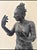 A textured, impressionist composite sculpture of a standing female figure, likely a dancer, caught mid-gesture with one...