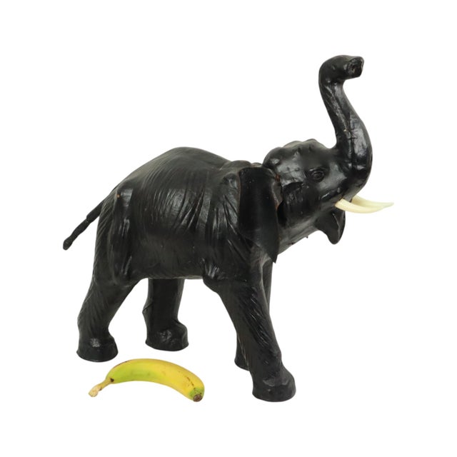 Large vintage elephant, rare figure in this size, made of papier-mâché and covered in black leather. The elephant features...