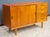 Beautiful small teak sideboard with four drawers and two sliding doors that reveal a horizontal shelf. Offering ample...