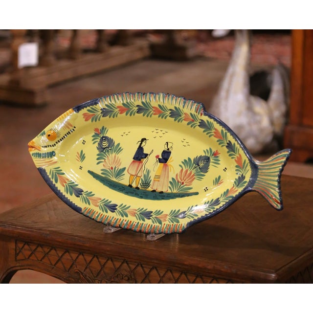 Bring cheerful Breton character to a table, kitchen, or wall display with this colorful faience fish platter. Crafted in...