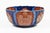 Large Imari punch bowl with a ribbed body and a scalloped or fluted rim, the alternating shaped panels contain elaborate...