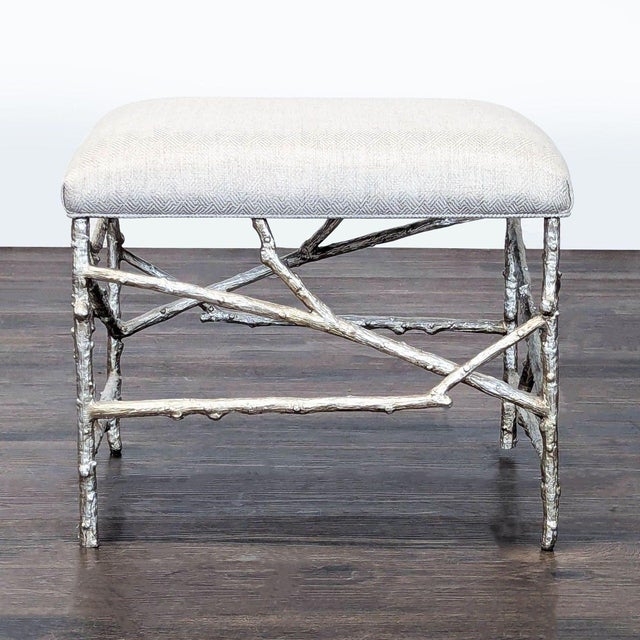 An upholstered ottoman with a branch-style iron base in transitional silver. Brand: John-Richard. Original Price: $1812....