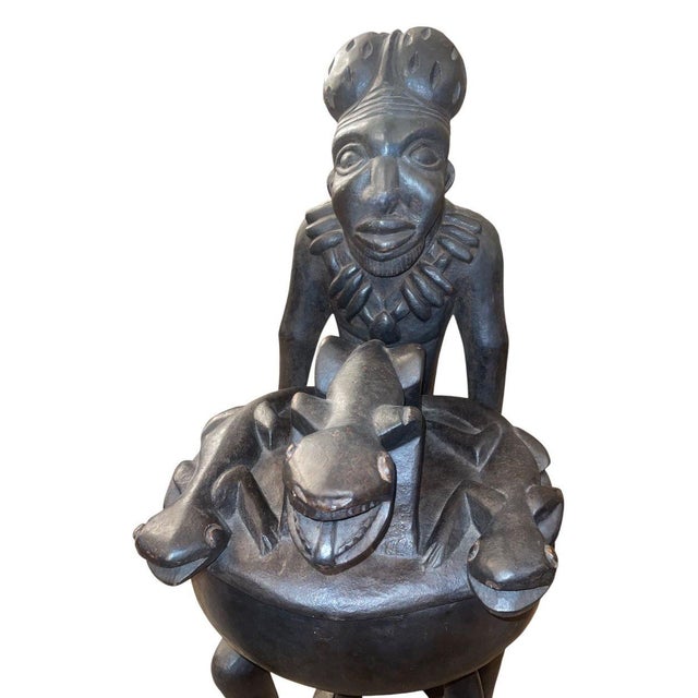 A monumental and powerfully carved Yoruba figural ritual vessel from Nigeria, dating to the mid-20th century. This...