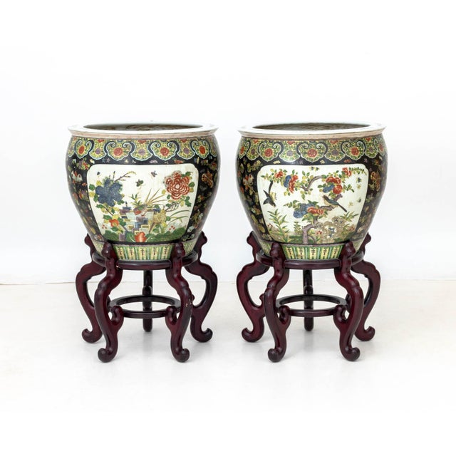 Pair of Chinese Famille Noir Porcelain Fish Bowls, each with iron red six character mark to underside and carved wood...