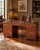 A handsome Theodore Alexander campaign-style executive desk inspired by late-19th-century British military furniture....