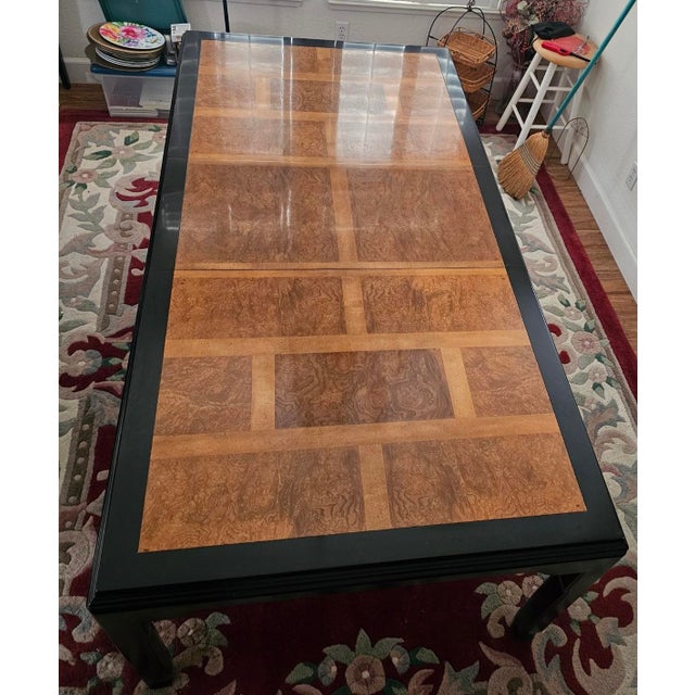 Crafted with high-quality hardwood, this table showcases a stunning burl wood top and sleek Ming inspired black lacquer...