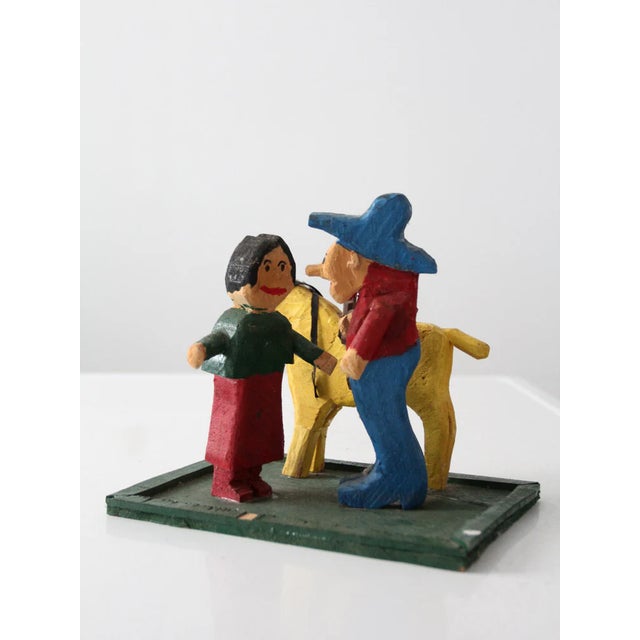 Add a touch of Western folk art to your decor with this handcrafted wood cowboy figure with his two loves... his lady and...