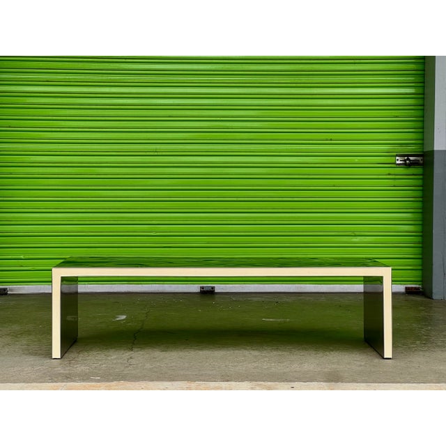 This dramatic table is made of reflective, polished stainless steel sheet laminated onto Styrofoam core, with white resin-...