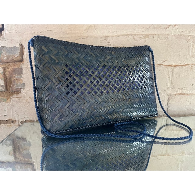Vintage 1980s blue-toned woven crossbody bag made in The Philippines. Lightweight with lacquered and lattice design and...