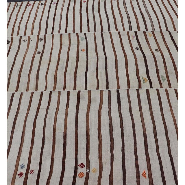 Measures: 14'8 x 18'6 This flat-weave tribal Turkish kilim has been hand-woven in wool. The rug features an all-over sub-...