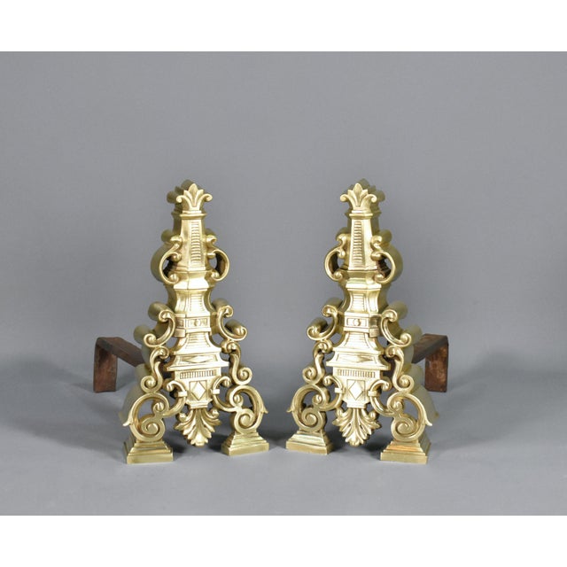This elegant pair of French brass fire dogs dates to the early 20th century and was sourced in southwest France. Featuring...