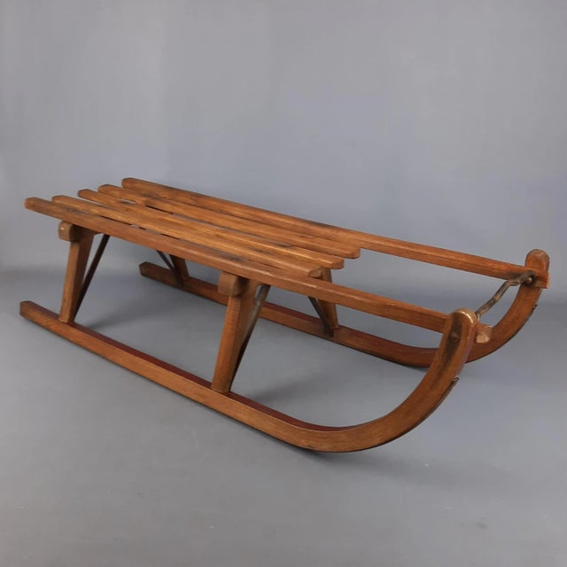 A charming, handcrafted antique/vintage sled, estimated to date back to the 1940s or earlier. This piece is a true...