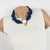This elegant Angela Caputi, made-in-Italy resin choker necklace features chunky carved pebble beads with a central round...