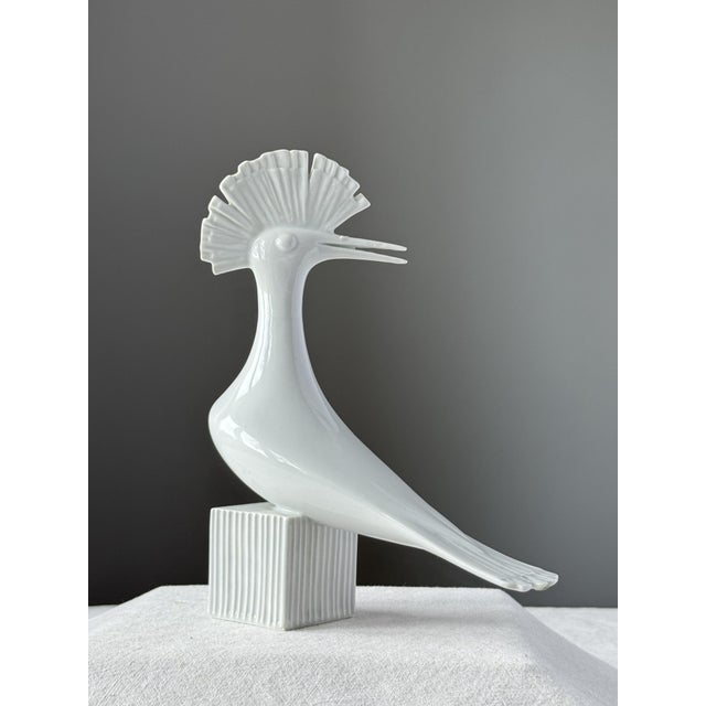 The figurine has a slightly chipped beak and manufacturing imperfections on the beak and on the underside of the tail, all...