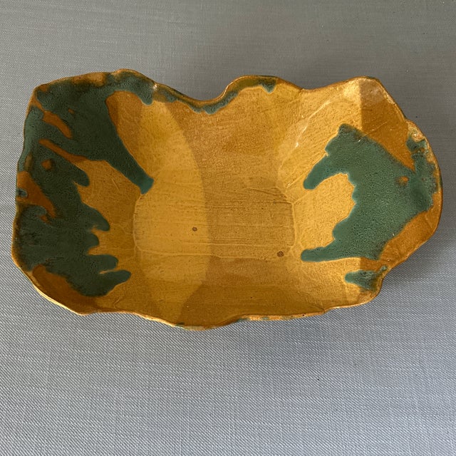 Fun shaped ceramic yellow and blue glazed pottery bowl. Signed on the bottom by KDE.