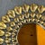 This is a stunning Brutalist Sunburst Wall Mirror. Crafted of torch cut gold tone metal with three graduating rings...